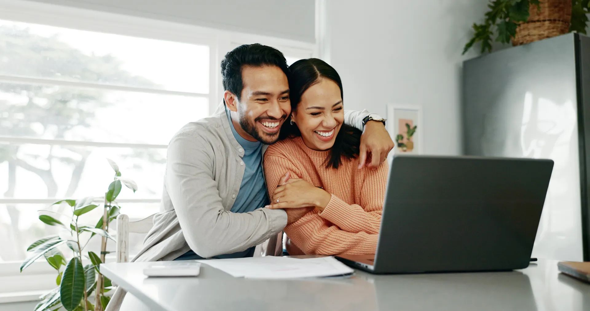 Couple reviewing their budget together at a laptop